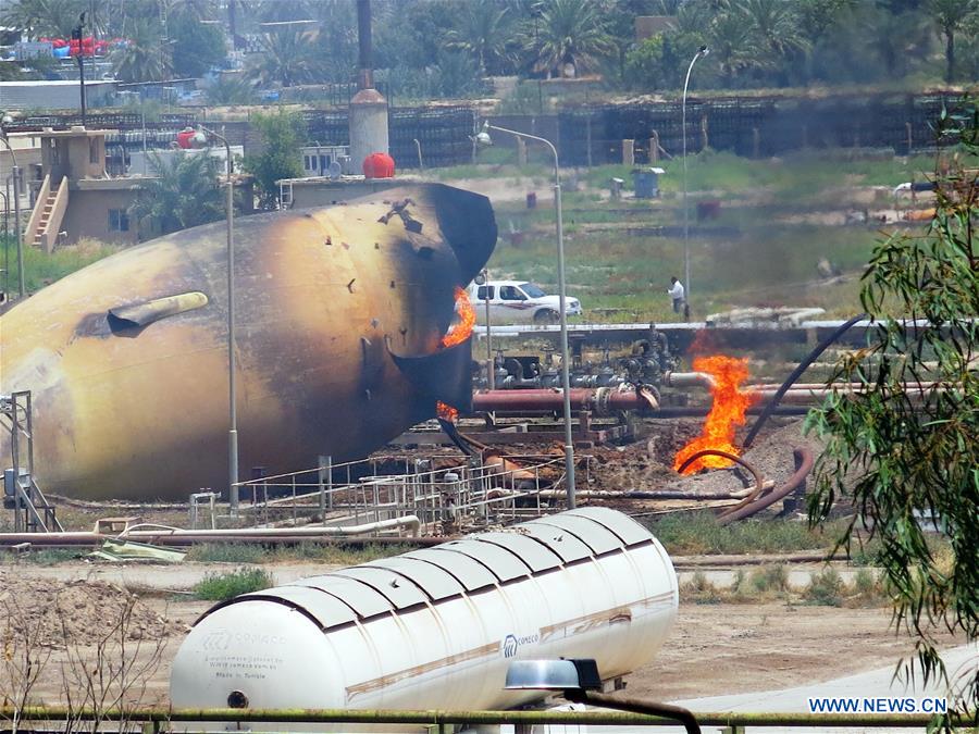 A storage gas tank is on fire at a gas plant after it was attacked by Islamic State (IS) suicide bombers, in Taji area, northern suburb of the Iraqi capital of Baghdad, May 15, 2016. Up to seven security members and civilian workers were killed and 24 others wounded on Sunday, as Iraqi security forces foiled an attempt by Islamic State (IS) suicide bombers to seize and destroy a gas plant in a northern suburb of Baghdad, an Interior Ministry source said. (Xinhua/Khalil Dawood) 