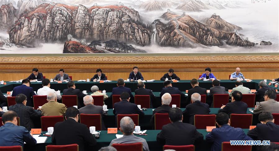 Chinese President Xi Jinping (C back) addresses a symposium discussing the country