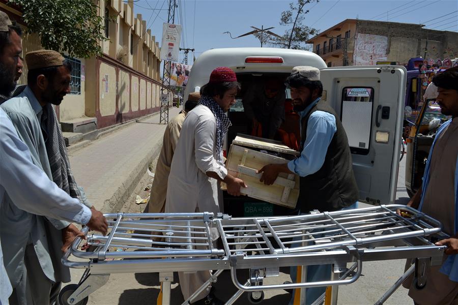 People transfer a dead body to a civil hospital in southwest Pakistan