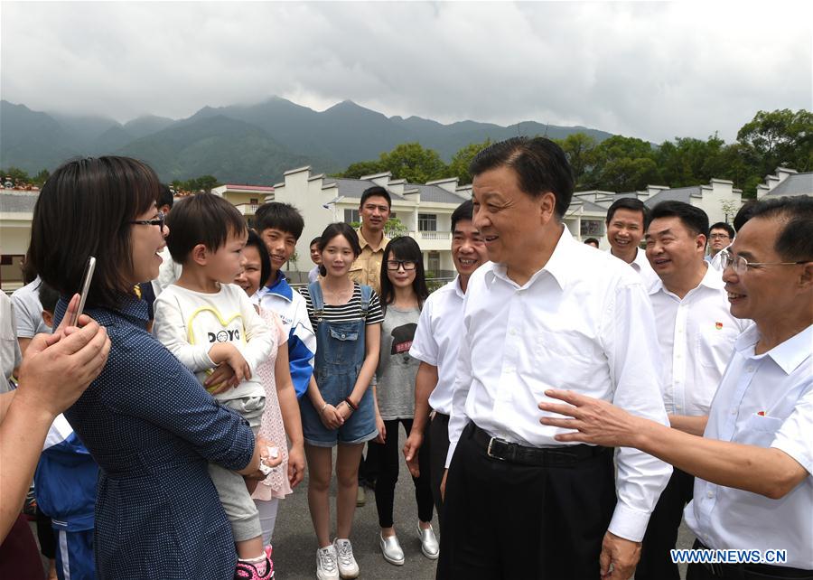 Liu Yunshan(2nd R front), a member of the Standing Committee of the Political Bureau of the Communist Party of China Central Committee, talks with villagers of Wushiling Village in Ruyuan Yao Autonomous County, south China