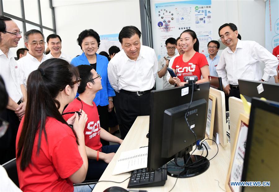 Liu Yunshan, a member of the Standing Committee of the Political Bureau of the Communist Party of China Central Committee, talks with students while visiting South China Normal University in Guangzhou, capital of south China