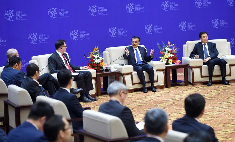 Chinese Premier Li Keqiang talks with business leaders on the sidelines of the China Big Data Industry Summit & China E-commerce Innovation and Development Summit in Guiyang, capital of southwest China
