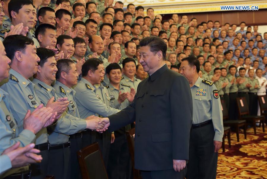 Chinese President Xi Jinping shakes hands with senior military officers stationed in Heilongjiang, in Harbin, capital of northeast China