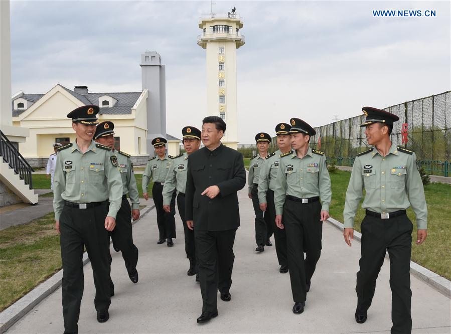 Chinese President Xi Jinping talks with military officers on Heixiazi Island, northeast China