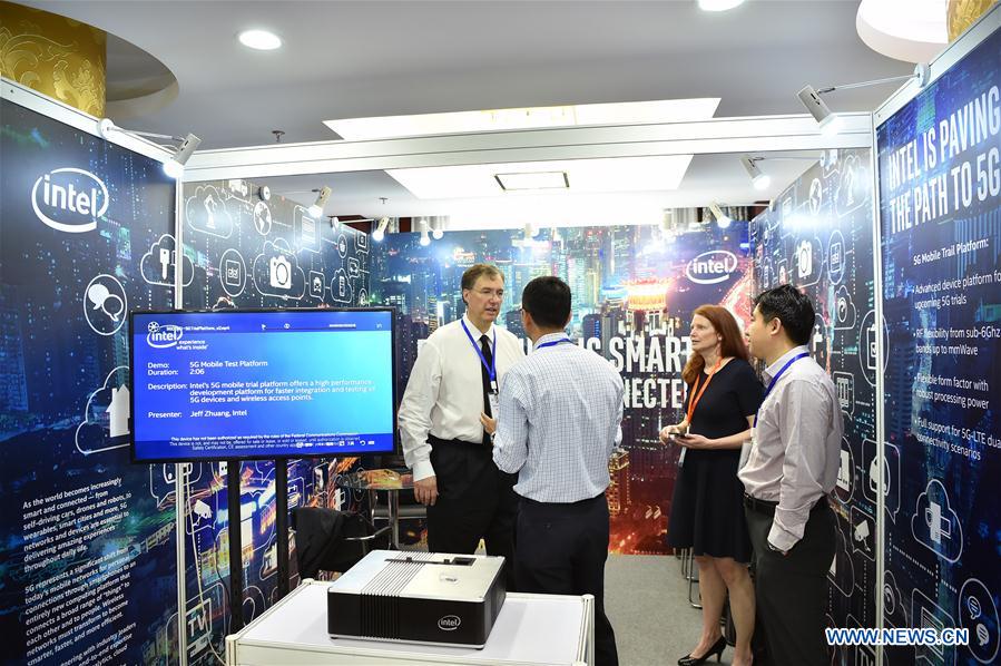 Participants consult at the exhibition stand of Intel company during the first Global 5G Event in Beijing, capital of China, May 31, 2016. The theme of the two-day event is "building 5G technology ecosystem". (Xinhua/Li Xin)