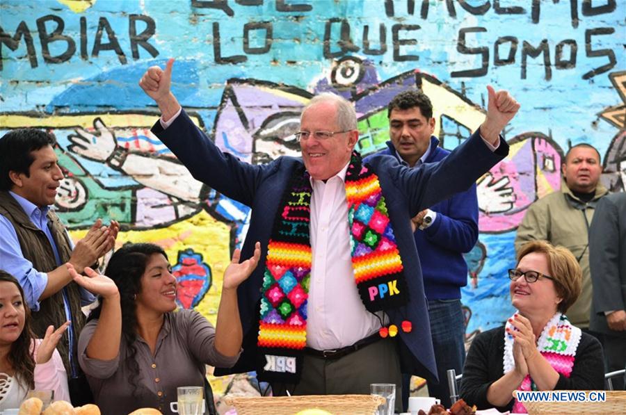 LIMA, June 9, 2016 (Xinhua) -- Image taken on June 5, 2016 shows the presidential candidate of the party Peruvians for Change (PPK), Pedro Pablo Kuczynski (C), reacting during a breakfast with neighbors of the La Victoria district before casting his vote in the second round of the presidential elections, in Lima, Peru. Peruvian economist Pedro Pablo Kuczynski will be the next president of Peru, the National Office of Electoral Processes (ONPE) confirmed at 4 p.m. Thursday afternoon. (Xinhua/Str) 