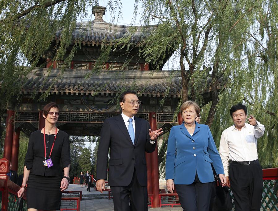 Chinese Premier Li Keqiang (2nd L) walks with German Chancellor Angela Merkel (2nd R) on her visit to China for the fourth round of China-Germany intergovernmental consultation before their meeting at the Summer Palace in Beijing, capital of China, June 12, 2016. (Xinhua/Pang Xinglei)