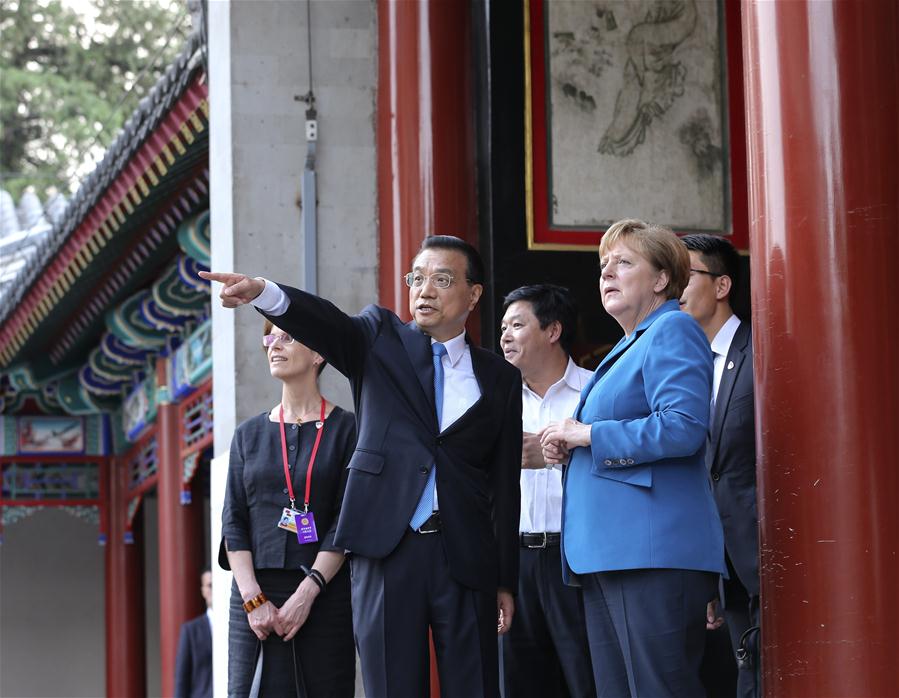 Chinese Premier Li Keqiang (C) talks with German Chancellor Angela Merkel (R) on her visit to China for the fourth round of China-Germany intergovernmental consultation before their meeting at the Summer Palace in Beijing, capital of China, June 12, 2016. (Xinhua/Pang Xinglei)