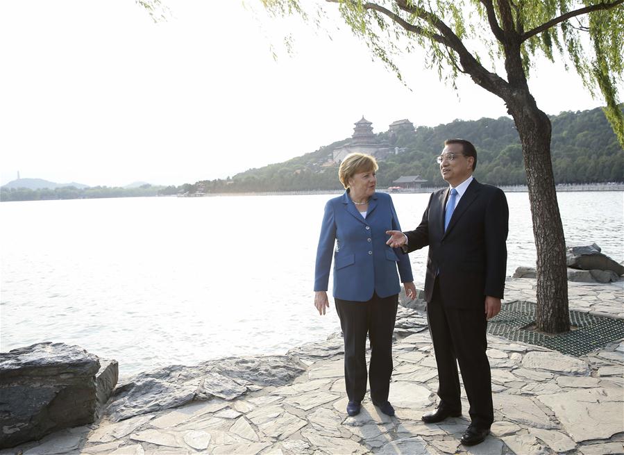 Chinese Premier Li Keqiang (R) walks with German Chancellor Angela Merkel on her visit to China for the fourth round of China-Germany intergovernmental consultation before their meeting at the Summer Palace in Beijing, capital of China, June 12, 2016. (Xinhua/Pang Xinglei)
