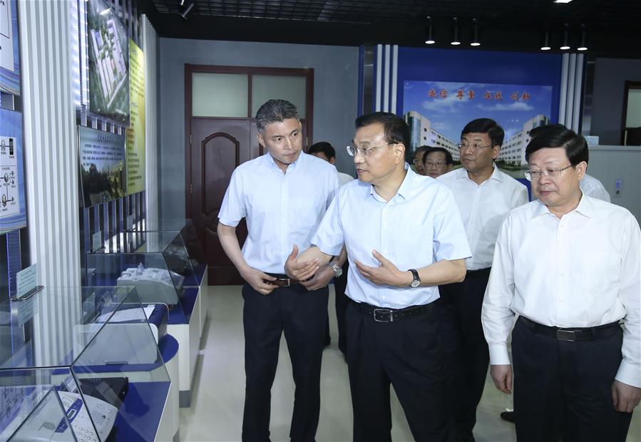 Chinese Premier Li Keqiang (2nd R, front) visits Tianjin Optical Electrical Group Co., Ltd. during an inspection tour in Tianjin, north China, June 26, 2016. (Xinhua/Pang Xinglei)