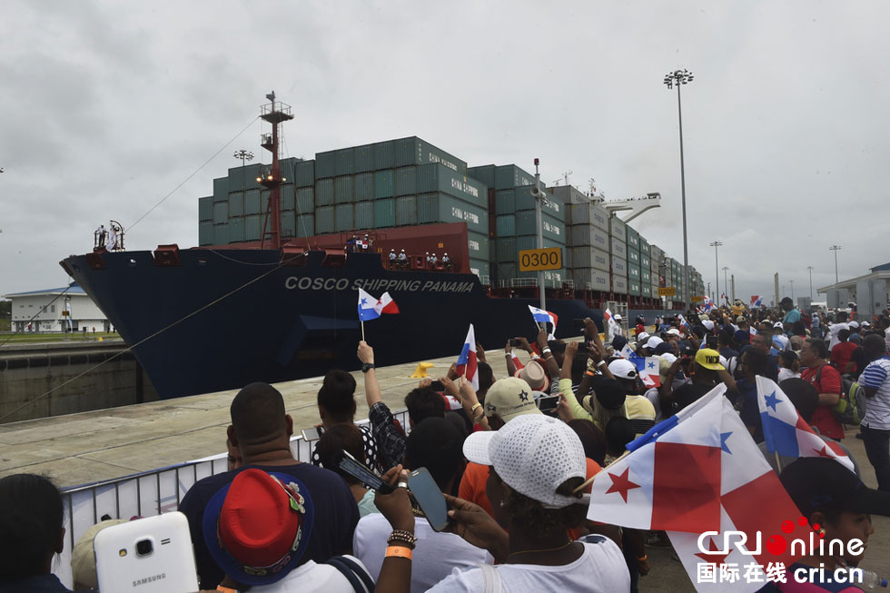 A giant Chinese-chartered freighter nudged its way through the Panama Canal on Sunday to mark the completion of nearly a decade of expansion work expected to boost global trade. 