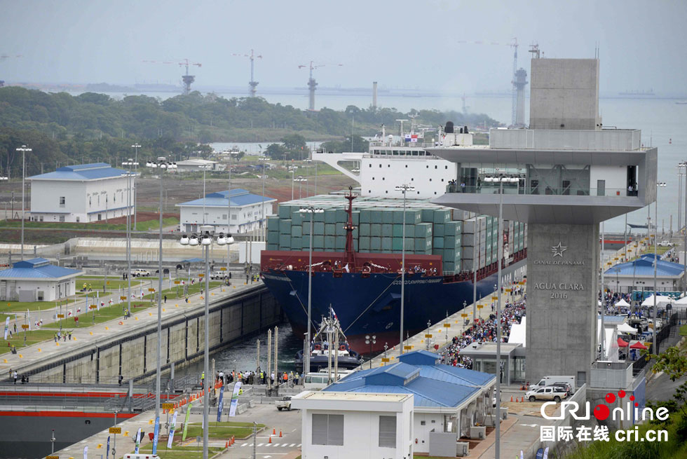 A giant Chinese-chartered freighter nudged its way through the Panama Canal on Sunday to mark the completion of nearly a decade of expansion work expected to boost global trade. 