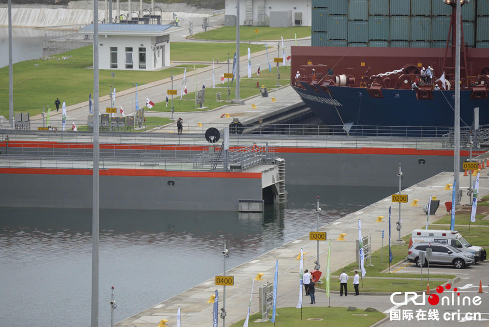 A giant Chinese-chartered freighter nudged its way through the Panama Canal on Sunday to mark the completion of nearly a decade of expansion work expected to boost global trade. 