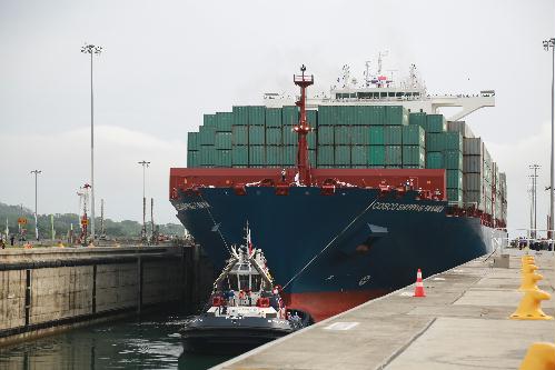 A giant Chinese-chartered freighter nudged its way through the Panama Canal on Sunday to mark the completion of nearly a decade of expansion work expected to boost global trade. 