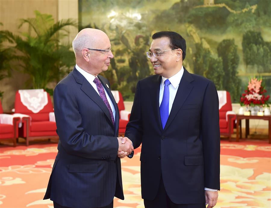 Chinese Premier Li Keqiang (R) meets with Klaus Schwab, founder and executive chairman of the World Economic Forum, in Tianjin, north China, June 26, 2016. 