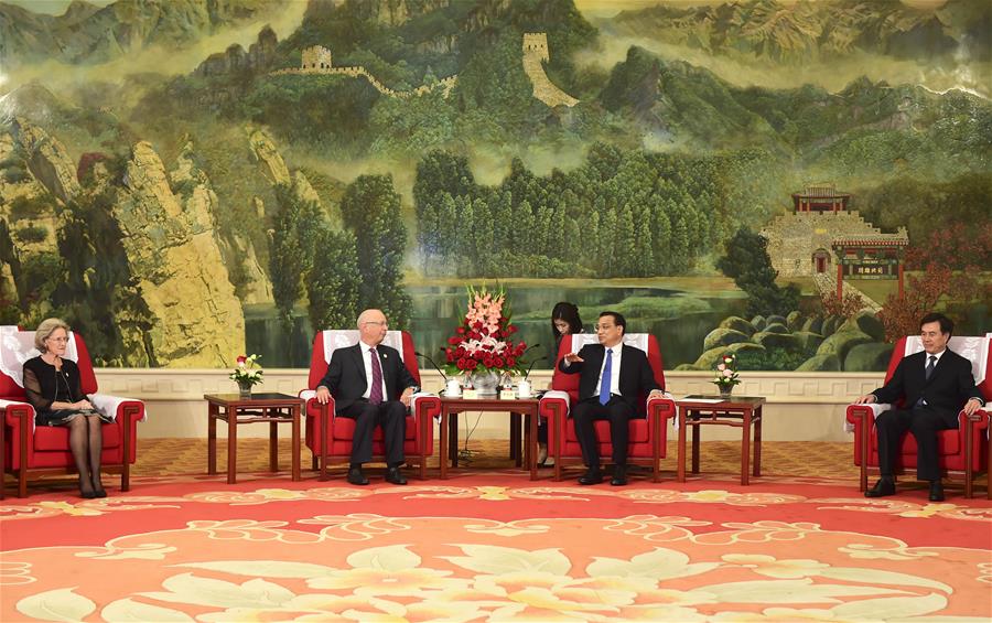 Chinese Premier Li Keqiang (2nd R) meets with Klaus Schwab (2nd L), founder and executive chairman of the World Economic Forum, in Tianjin, north China, June 26, 2016. 