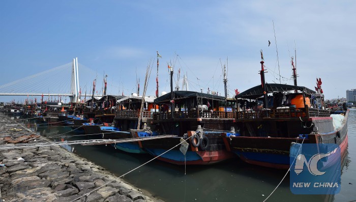 Fishing boats berth at a whart in Haikou, capital of south China