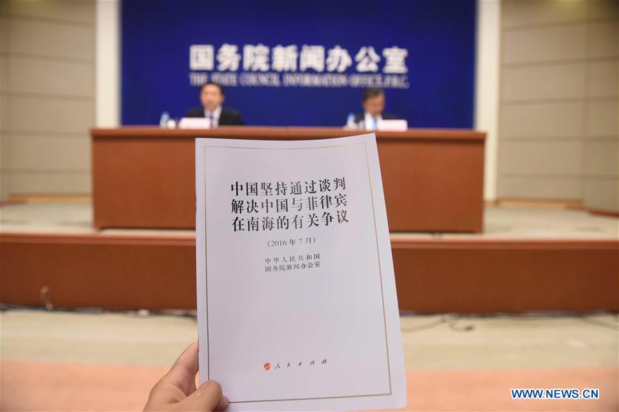 Photo taken on July 13, 2016 shows the white paper titled "China Adheres to the Position of Settling Through Negotiation the Relevant Disputes Between China and the Philippines in the South China Sea" in Beijing, capital of China. The Chinese government on Wednesday issued the white paper. (Xinhua/Chen Yehua) 