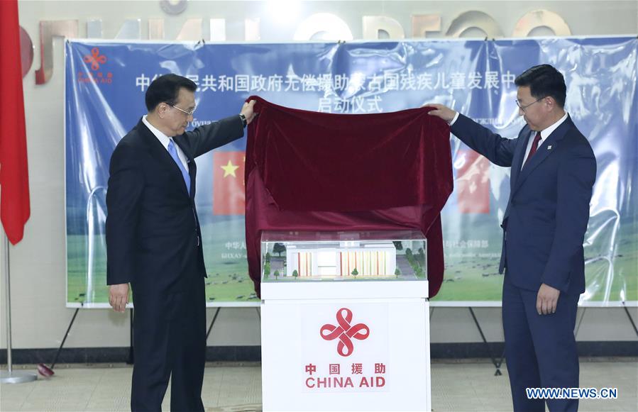 Chinese Premier Li Keqiang (L) and Mongolian Prime Minister Jargaltulga Erdenebat attend the launching ceremony of a handicapped children development center aided by China, in Ulan Bator, Mongolia