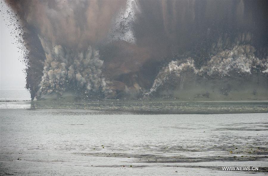 WUHAN, July 14, 2016 (Xinhua) -- A dike between the Liangzi Lake and the Niushan Lake is blown up in central China