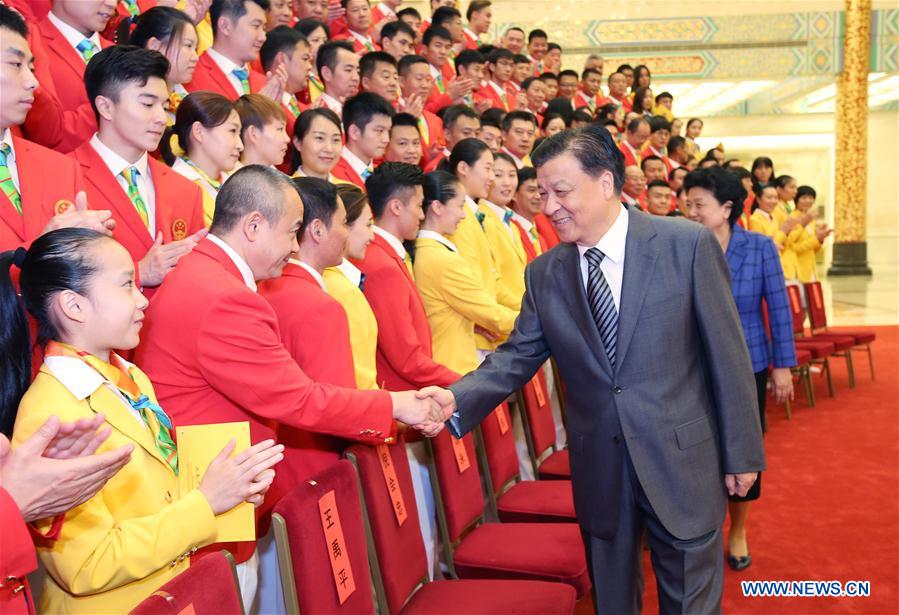 Liu Yunshan (R front), a member of the Standing Committee of the Political Bureau of the Communist Party of China Central Committee, meets with the Chinese delegation to the upcoming Rio Olympic Games prior to the launch ceremony, in Beijing, capital of China, July 18, 2016. (Xinhua/Yao Dawei) 