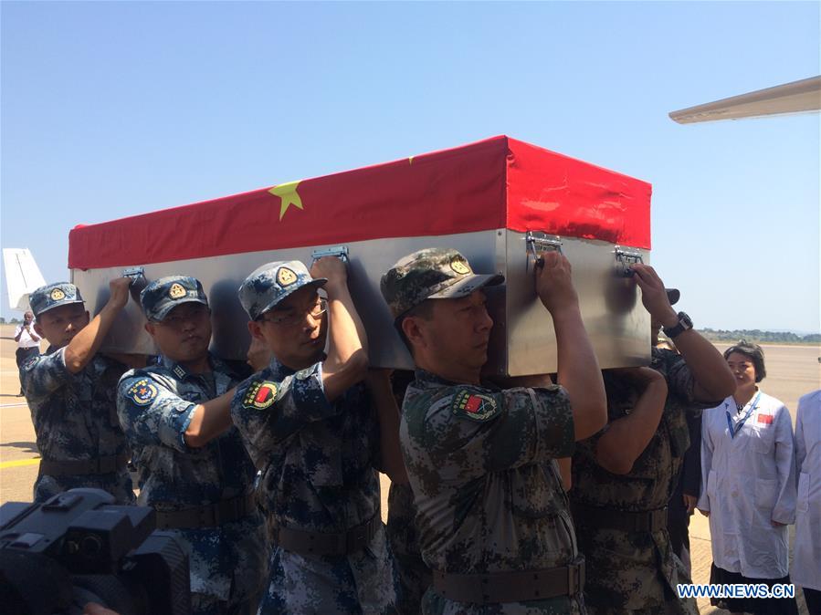 Chinese military team members carry the coffin of the Chinese peacekeeper killed in the recent fighting in South Sudan to an airplane at Entebbe International Airport, Uganda, on July 19, 2016. The remains of two Chinese UN peacekeepers killed in the recent fighting in South Sudan left Uganda on Tuesday afternoon for China. (Xinhua/Yuan Qing) 