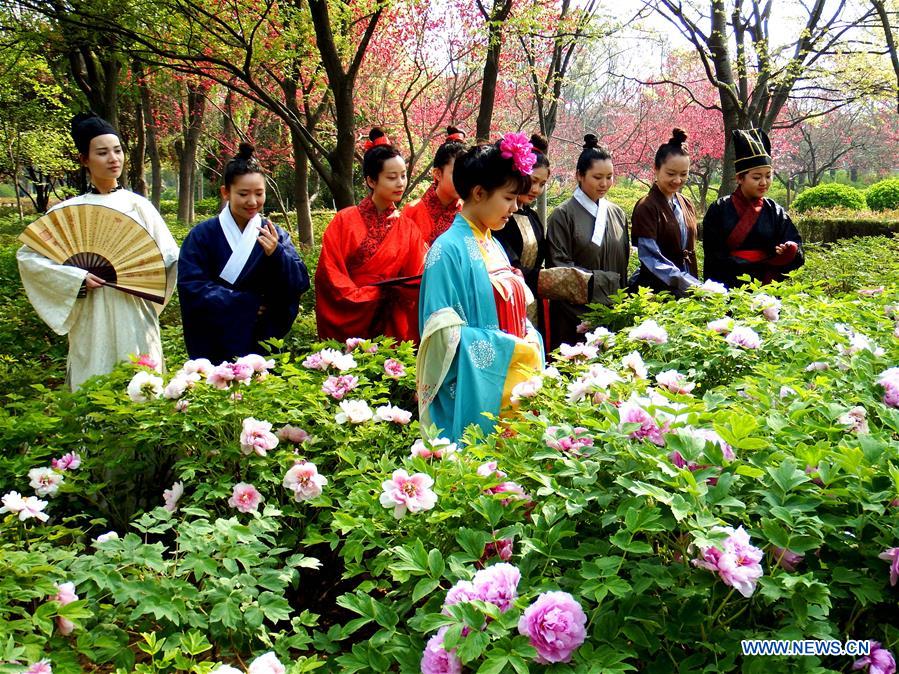 LUOYANG, April 2, 2016 (Xinhua) -- Actors view peony flowers during the Peony Cultural Festival in Luoyang, central China