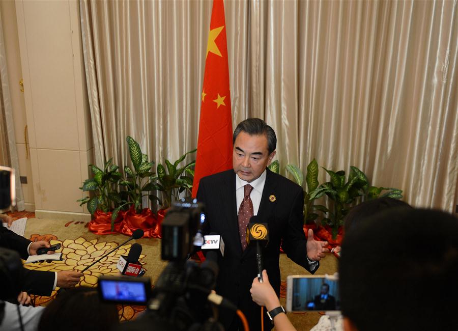 Chinese Foreign Minister Wang Yi(C) speaks to the press after the meetings in Vientiane, capital of Laos, on July 26, 2016. Chinese Foreign Minister Wang Yi said here on Tuesday that China and members of the Association of Southeast Asian Nations (ASEAN) have exerted joint efforts to make the ministerial meetings focus on dialogue and cooperation. (Xinhua/Liu Ailun)