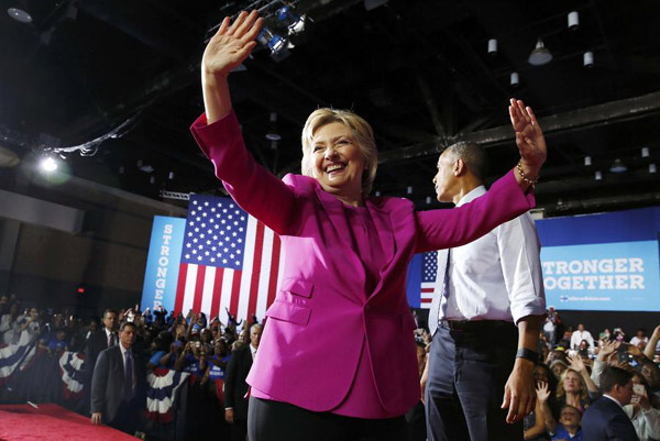 Democratic US presidential candidate Hillary Clinton acknowledges supporters during a campaign rally, where she received the endorsement of US President Barack Obama (R), in Charlotte, North Carolina, US, July 5, 2016. [Photo: Agencies]