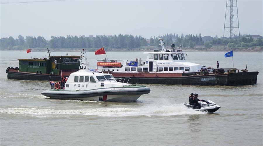 Vessels of local maritime administration and public security bureau take part in a water traffic control drill on the Qiantang River in Hangzhou, capital of east China