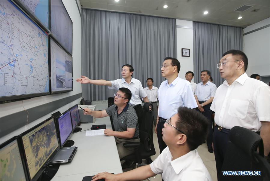 Chinese Premier Li Keqiang (3rd R front) visits State Flood Control and Drought Relief Headquarters and chairs over a special meeting on flood control and disaster relief as well as settlement and reconstruction in the next phase of deployment in Beijing, capital of China, July 30, 2016. (Xinhua/Yao Dawei)