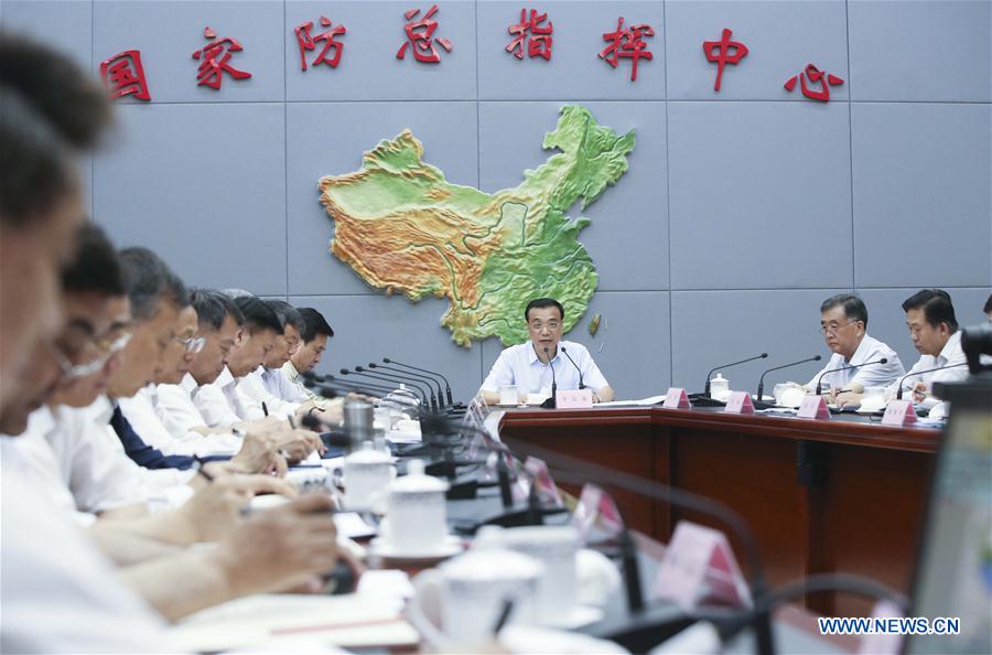 Chinese Premier Li Keqiang (C back) visits State Flood Control and Drought Relief Headquarters and chairs over a special meeting on flood control and disaster relief as well as settlement and reconstruction in the next phase of deployment in Beijing, capital of China, July 30, 2016. (Xinhua/Yao Dawei)