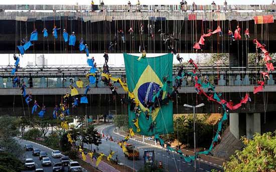 People rappel from a bridge to form the Olympic rings in Sao Paulo, Brazil.