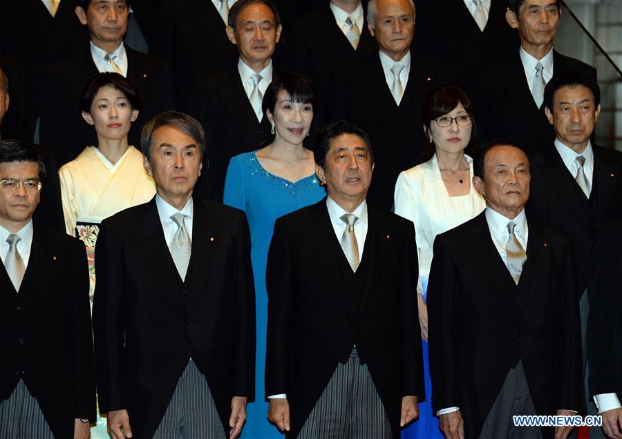 Japanese Prime Minister Shinzo Abe (2nd R, Front) and cabinet ministers pose during a photo session at Abe