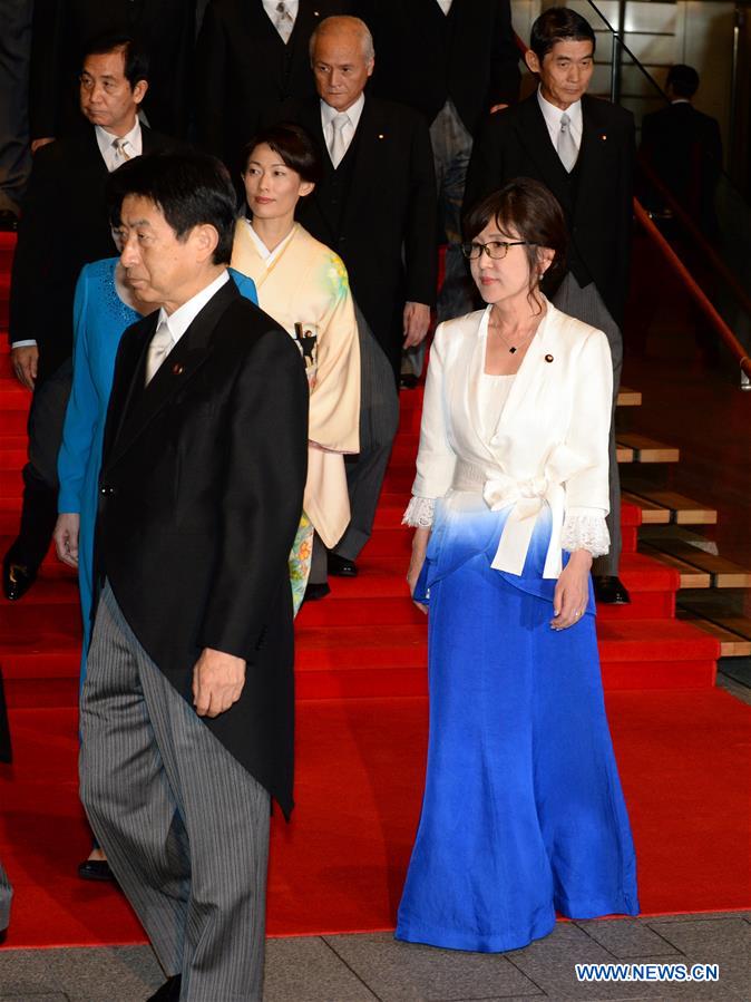 Newly appointed Japanese Defense Minister Tomomi Inada (R, Front) and other cabinet ministers leave after a photo session at Abe