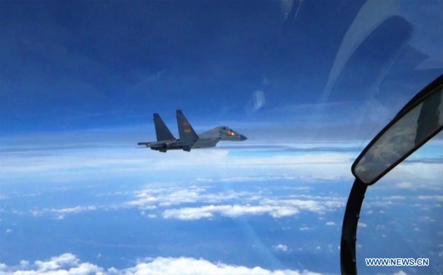 A Chinese fighter plane partols over the South China Sea. Chinese Air Force aircraft, including H-6K bombers and Su-30 fighters, have completed a patrol of airspace above the Nansha and Huangyan islands in the South China Sea, said a spokesperson Saturday. The flight is part of actual combat training to improve the Air Force