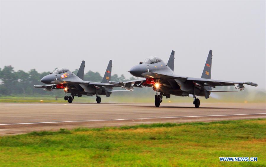 Two Su-30 fighters take off to partol over the South China Sea. Chinese Air Force aircraft, including H-6K bombers and Su-30 fighters, have completed a patrol of airspace above the Nansha and Huangyan islands in the South China Sea, said a spokesperson Saturday. The flight is part of actual combat training to improve the Air Force