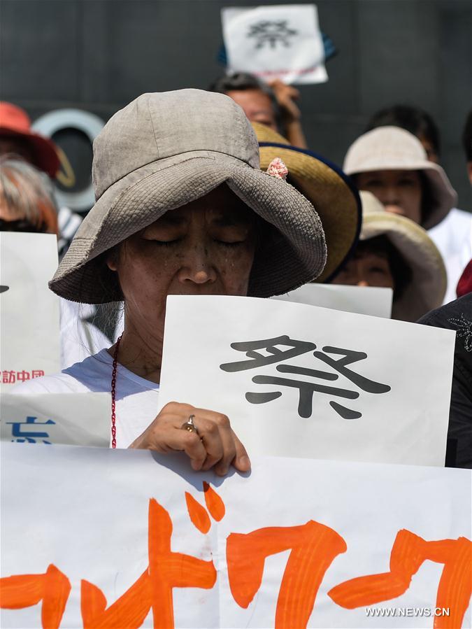 A Japanese delegate attends an assembly at the Memorial Hall of the Victims in Nanjing Massacre by Japanese Invaders in Nanjing, capital of east China