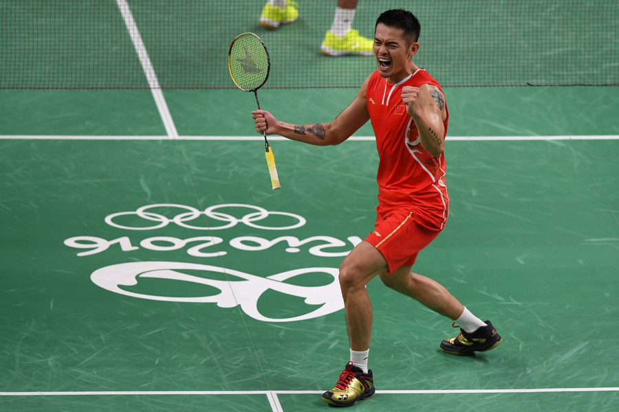 Lin Dan of China celebrates after winning his match against Srikanth Kidambi of India in badminton men