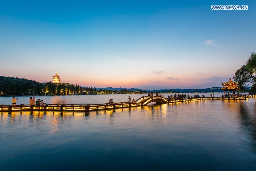 Photo taken on Aug. 29, 2016 shows the Leifeng Pagoda and Long bridge in the sunset in the West Lake in Hangzhou, capital city of east China