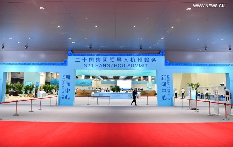 Staff members and volunteers work at the media center of the G20 summit in Hangzhou, capital of east China