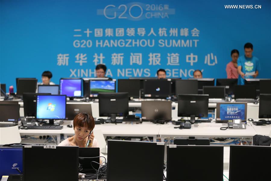 Xinhua staff members work at the media center of the G20 summit in Hangzhou, capital of east China