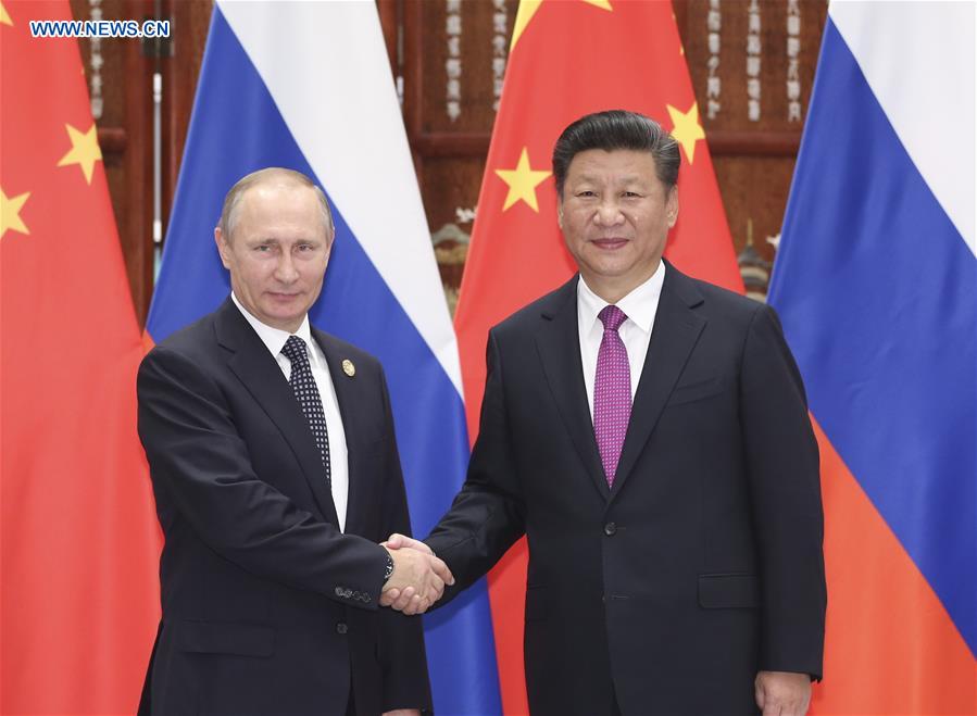 Chinese President Xi Jinping (R) meets with Russian President Vladimir Putin, who is here to attend the Group of 20 (G20) summit, in Hangzhou, capital of east China