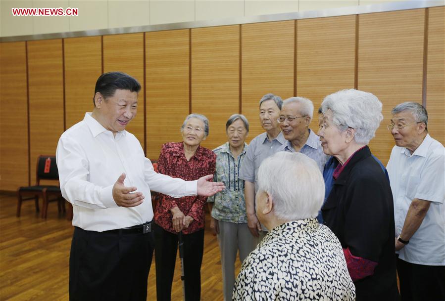 Chinese President Xi Jinping (1st L) talks to elder teachers during an inspection visit to Beijing Bayi School before the upcoming national Teacher