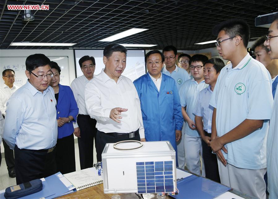 Chinese President Xi Jinping (3rd L) talks to teachers during an inspection visit to Beijing Bayi School before the upcoming national Teacher