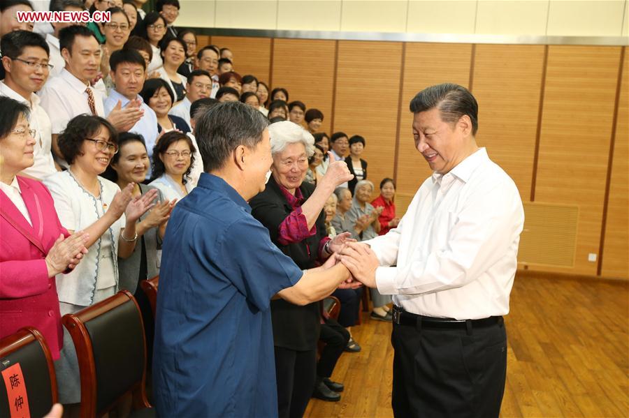 Chinese President Xi Jinping (1st R) shakes hands with representatives of teachers and students during an inspection visit to Beijing Bayi School before the upcoming national Teacher