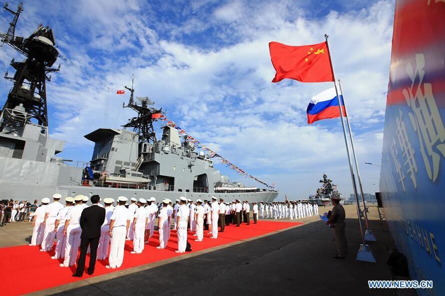 Officers and soldiers of Chinese Navy hold a welcome ceremony as a Russian fleet arrive at a port in Zhanjiang, south China