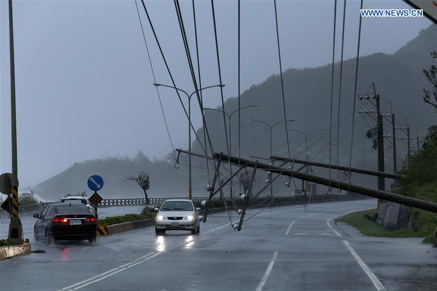 Electric line poles are blown down on a highway from Pingtung to Kenting in typhoon-hit Taiwan, southeast China, Sept. 14, 2016. Typhoon Meranti on Wednesday brought strong winds and heavy downpour to the island. (Xinhua) 