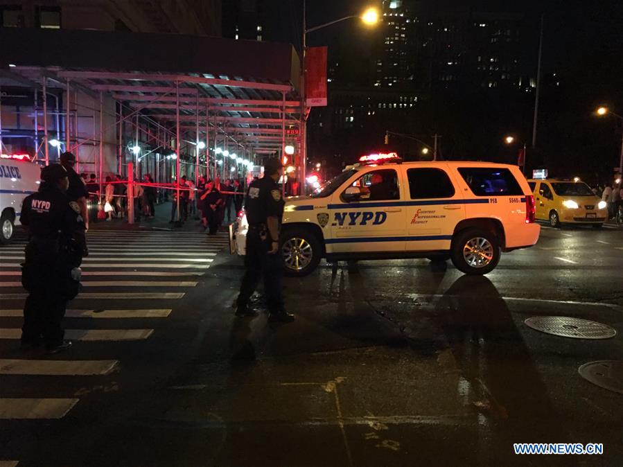 The cellphone photo taken on Sept. 17, 2016 shows policemen on duty near the site of an explosion in New York, the United States. A total of 25 people have been injured in an explosion in the Chelsea neighborhood of Manhattan on Saturday evening, and the cause of the blast is under investigation, the New York City Fire Department said. (Xinhua/Li Muzi)