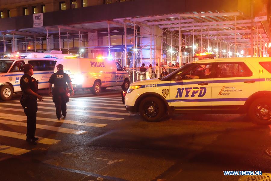 The photo taken on Sept. 17, 2016 shows policemen on duty near the site of an explosion in New York, the United States. A total of 25 people have been injured in an explosion in the Chelsea neighborhood of Manhattan on Saturday evening, and the cause of the blast is under investigation, the New York City Fire Department said. (Xinhua/Li Muzi)